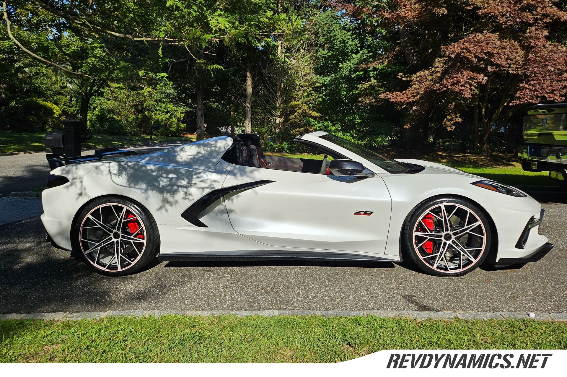 Corvette C8 with color matched rims in carbon black pearl white and red