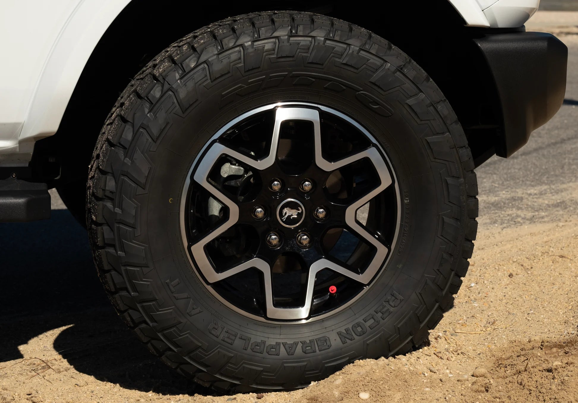 Off road wheel with valve stem tire deflator from over-sand